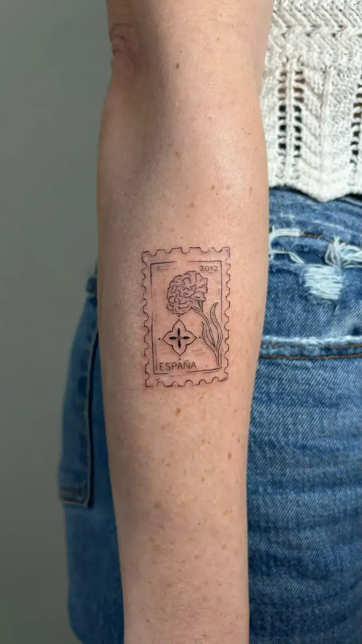 Botanical fine line branch tattoo suited for a holiday keepsake
