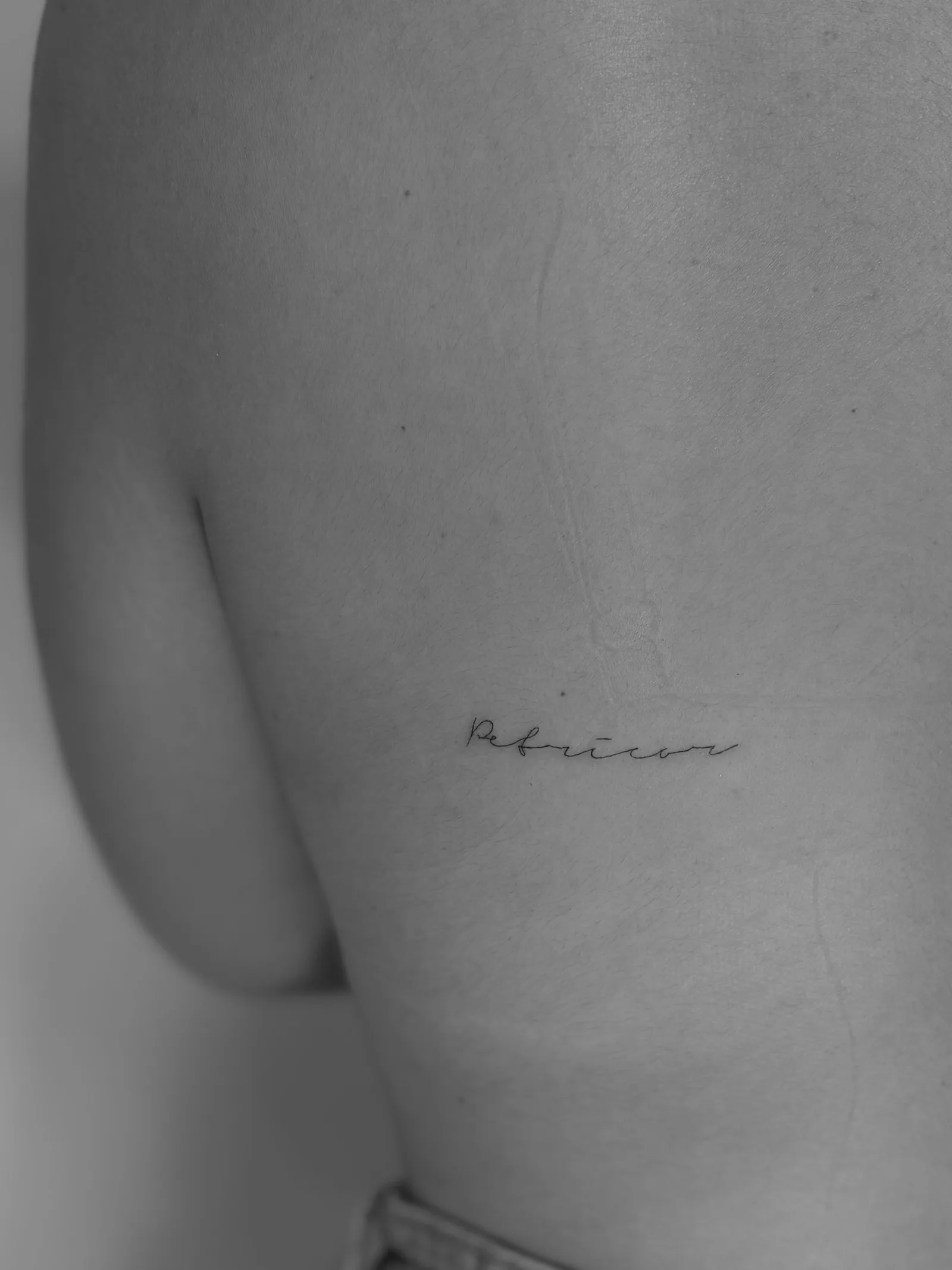 Single-line airplane tattoo celebrating a trip to Madrid