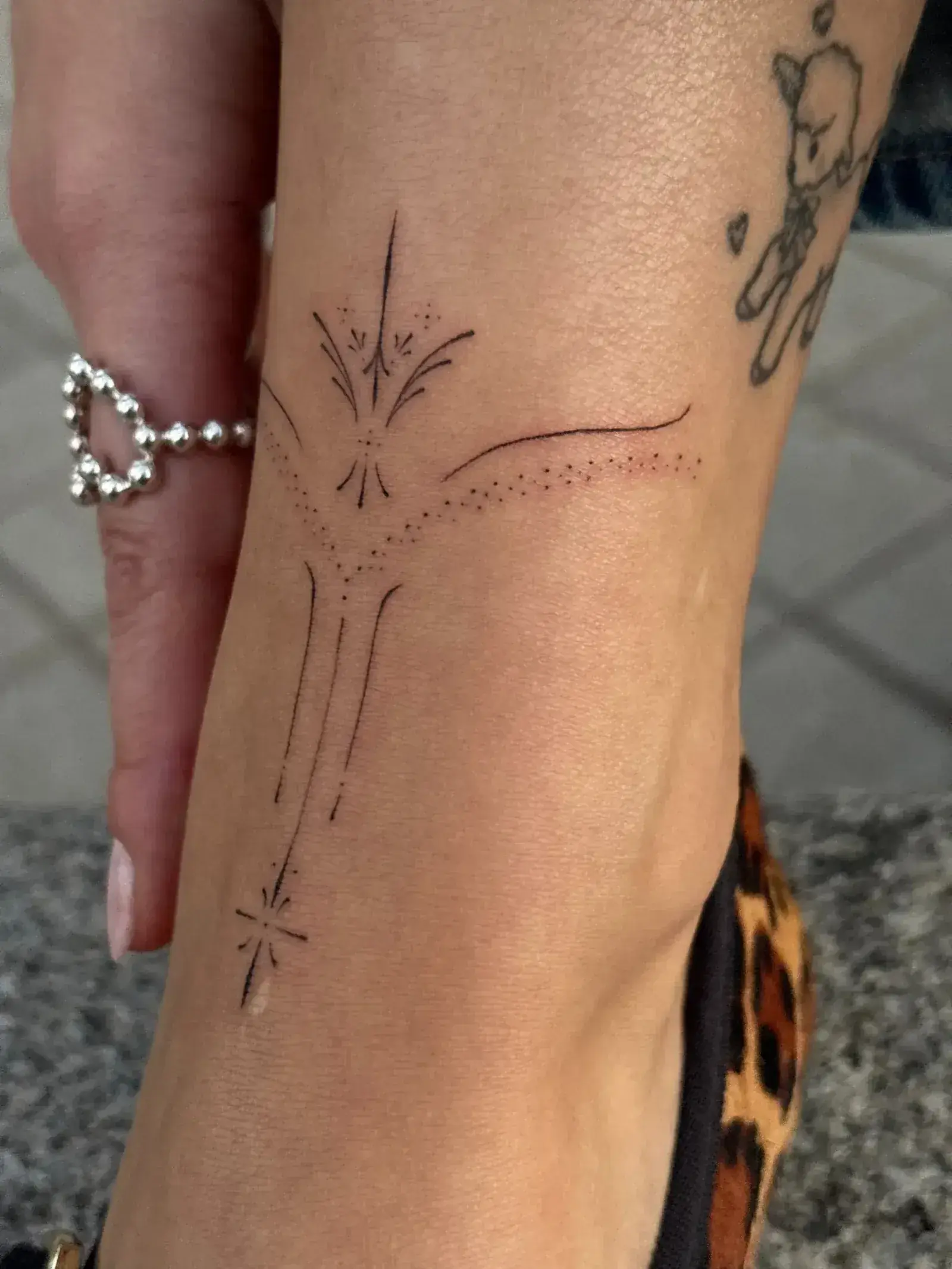 Fine line constellation dots connected by thin lines on shoulder