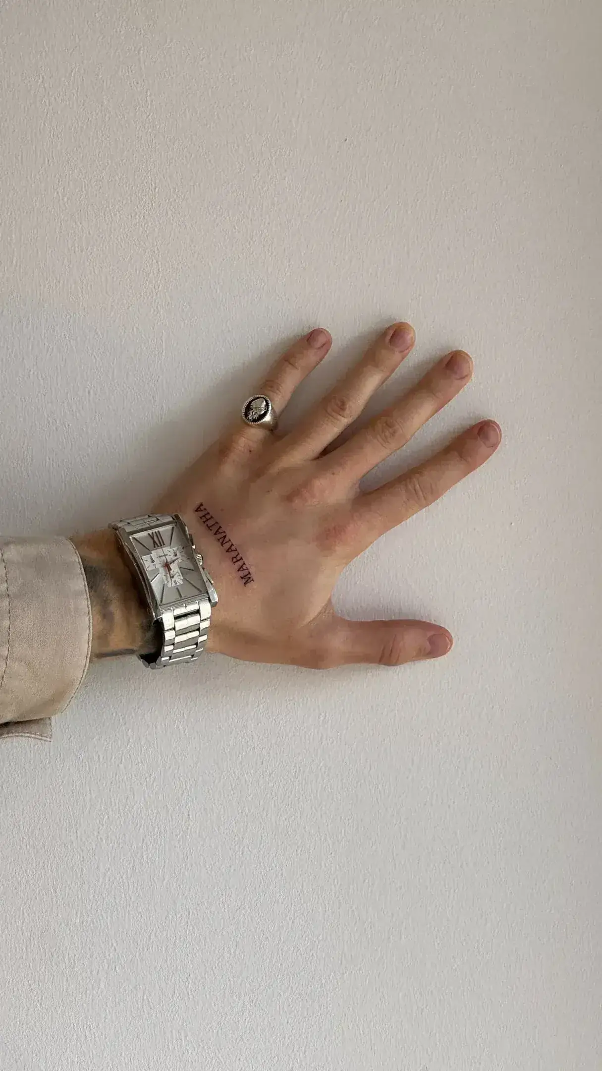 Coordinates of Madrid tattooed in thin lettering on wrist