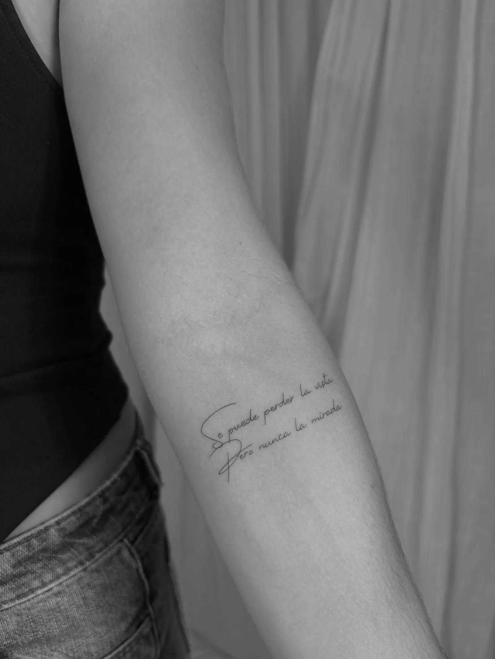 Olive branch fine line tattoo along the collarbone