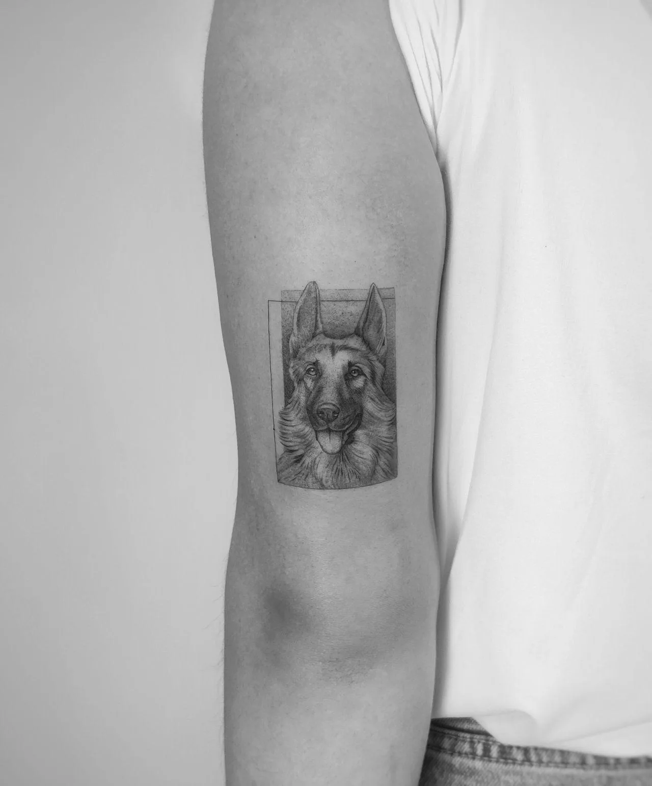 Medium dog tattoo Madrid — fine line portrait with soft shading