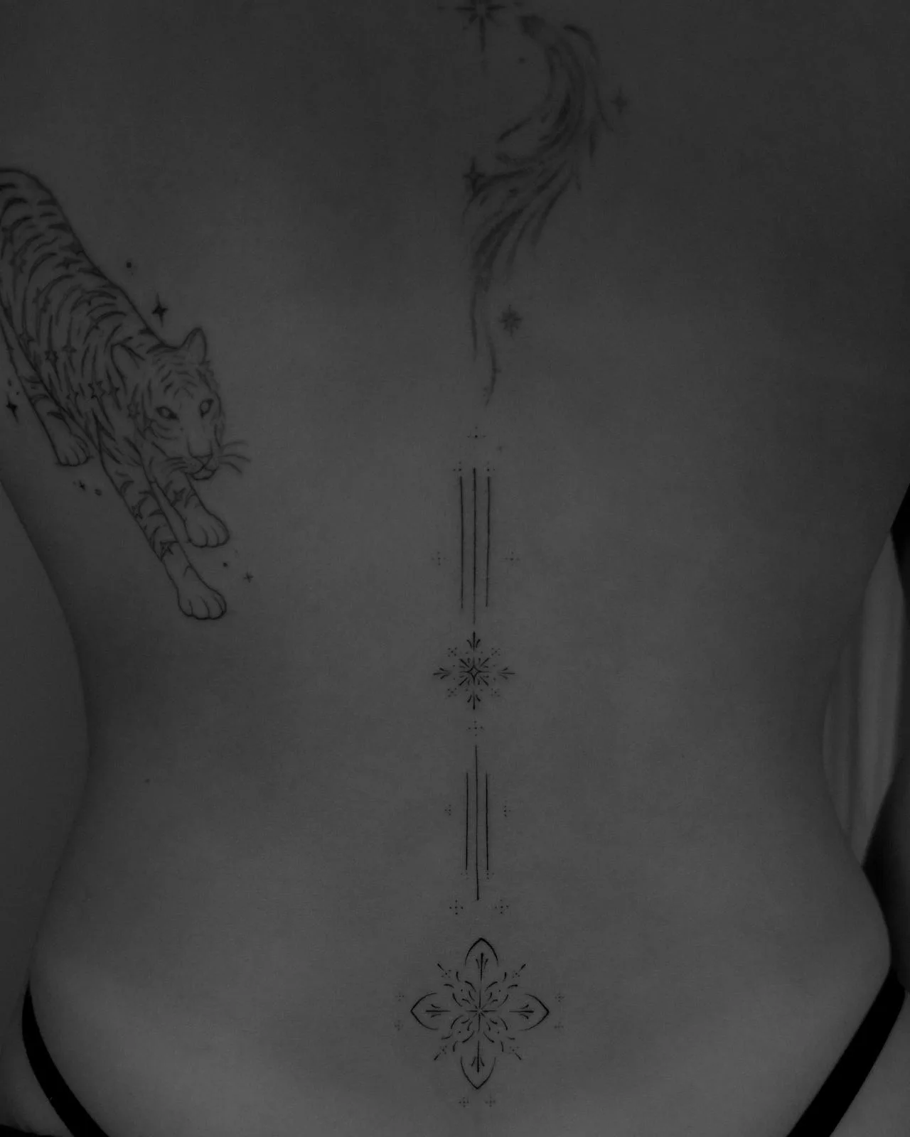Decorative ornamental piece bridging two existing tattoos